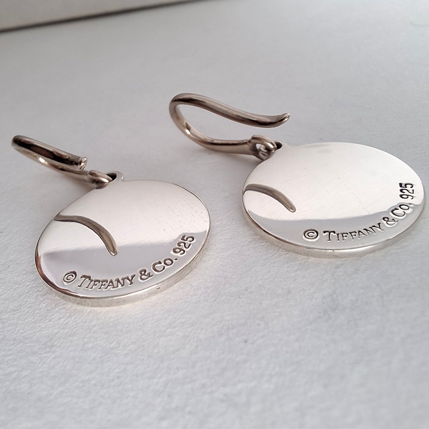 Return to Tiffany & Co Round Tag Charm Dangle Earrings in Sterling Silver