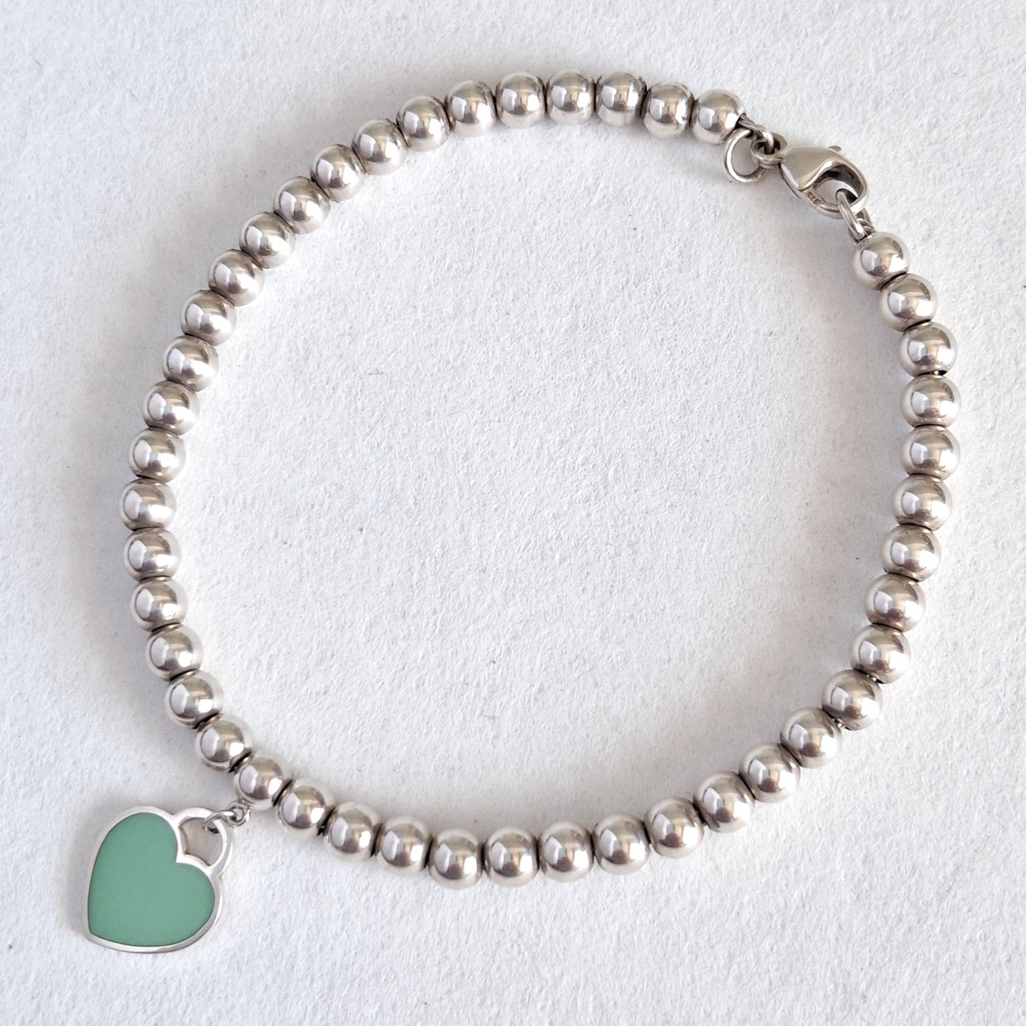 Return to Tiffany & Co 3mm Bead Bracelet with 10mm Blue Enamel Heart Charm in Sterling Silver