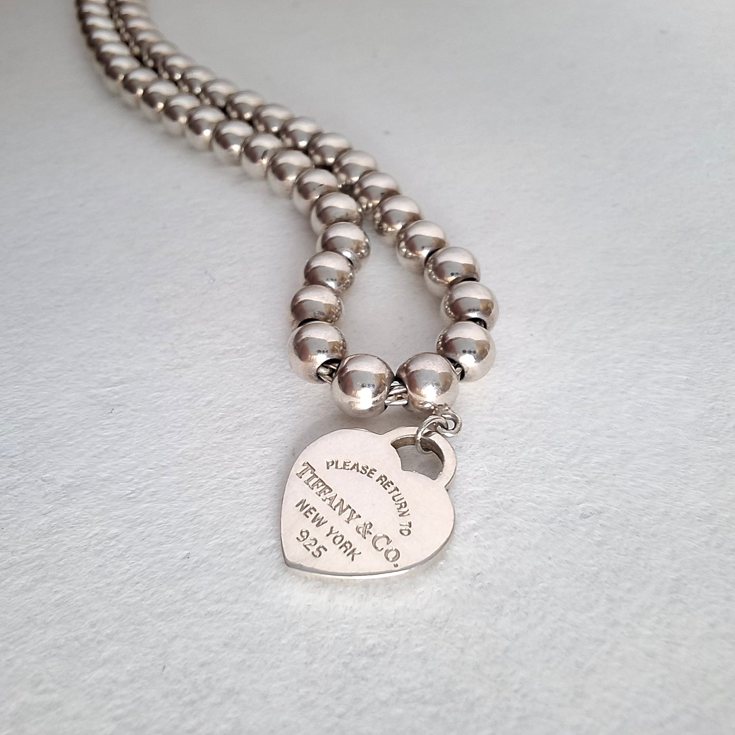 Return to Tiffany & Co 3mm Bead Bracelet with 10mm Blue Enamel Heart Charm in Sterling Silver