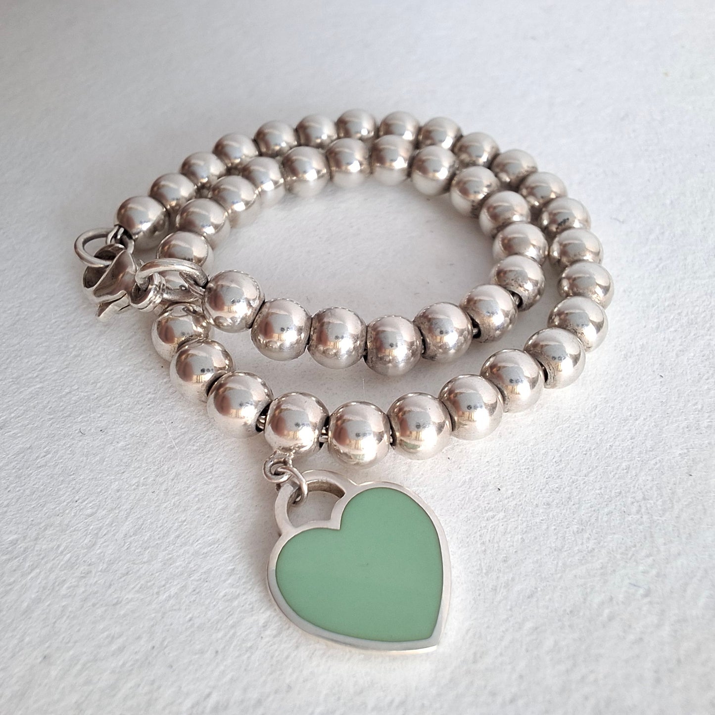 Return to Tiffany & Co 3mm Bead Bracelet with 10mm Blue Enamel Heart Charm in Sterling Silver