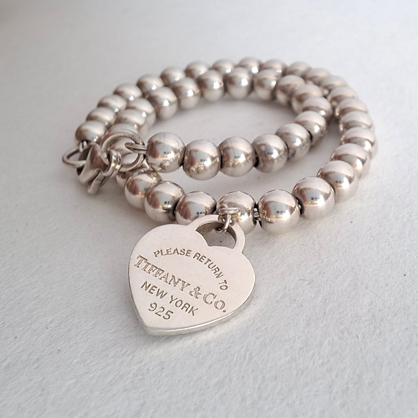 Return to Tiffany & Co 3mm Bead Bracelet with 10mm Blue Enamel Heart Charm in Sterling Silver