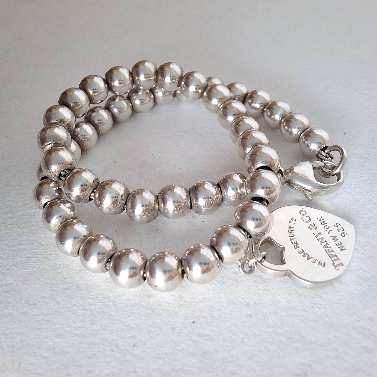 Return to Tiffany & Co 3mm Bead Bracelet with 10mm Blue Enamel Heart Charm in Sterling Silver